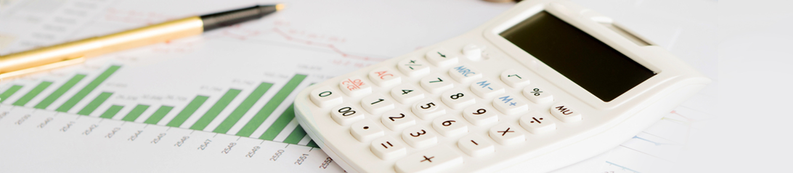 Calculator and pen on top of financial documents.